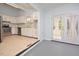 Kitchen features white cabinets, stainless steel appliances and backyard access at 5617 Laurel Crest Dr, Durham, NC 27712