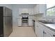 Stainless steel appliances and white cabinets in a galley kitchen at 5617 Laurel Crest Dr, Durham, NC 27712