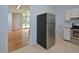Stainless steel refrigerator and partial view of living room at 5617 Laurel Crest Dr, Durham, NC 27712