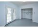 Laundry area with built-in shelving and French doors leading outside at 5617 Laurel Crest Dr, Durham, NC 27712
