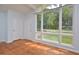Living room with hardwood floors, large windows, and a view of the yard at 5617 Laurel Crest Dr, Durham, NC 27712