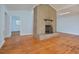 Living room with hardwood floors, brick fireplace, and access to other rooms at 5617 Laurel Crest Dr, Durham, NC 27712
