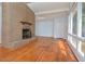 Living room with hardwood floors and a large brick fireplace at 5617 Laurel Crest Dr, Durham, NC 27712