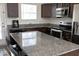 Modern kitchen with granite countertops and stainless steel appliances at 601 Joe Gibson Dr, Gibsonville, NC 27249
