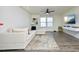 Living room featuring a sectional sofa, large TV, and hardwood floors at 601 Joe Gibson Dr, Gibsonville, NC 27249