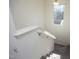 View of carpeted staircase from above, showing a window at the top of the stairs at 601 Joe Gibson Dr, Gibsonville, NC 27249