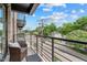 Relaxing balcony with a chair overlooking the neighborhood at 615 W Peace St # 307, Raleigh, NC 27605