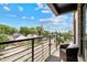 Neighborhood views from condo balcony with a cozy seating arrangement at 615 W Peace St # 307, Raleigh, NC 27605