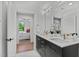Main bathroom with double sinks, modern fixtures, and a view to the main bedroom at 615 W Peace St # 307, Raleigh, NC 27605
