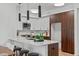 Contemporary kitchen featuring a large island, stainless steel appliances, and modern lighting at 615 W Peace St # 307, Raleigh, NC 27605
