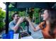 People raise a toast in the garden seating area outside the restaurant at 615 W Peace St # 307, Raleigh, NC 27605