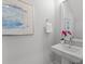Small bathroom with pedestal sink and floating shelves at 712 Jamescroft Way # 26, Rolesville, NC 27571