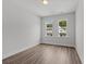 Well-lit bedroom featuring wood-look floors and two windows at 712 Jamescroft Way # 26, Rolesville, NC 27571