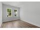 Bright bedroom with two windows and wood-look flooring at 712 Jamescroft Way # 26, Rolesville, NC 27571