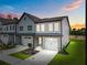 Charming new construction townhome boasts a one-car garage and beautiful gray siding at 712 Jamescroft Way # 26, Rolesville, NC 27571