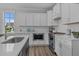 Modern kitchen with white cabinets, stainless steel appliances and subway tile backsplash at 712 Jamescroft Way # 26, Rolesville, NC 27571