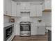 Modern kitchen with white cabinets, stainless steel appliances, and gas range at 712 Jamescroft Way # 26, Rolesville, NC 27571
