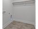 Laundry room with tile floor and built-in shelving at 712 Jamescroft Way # 26, Rolesville, NC 27571