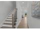 Modern staircase with dark wood treads and black metal balusters at 712 Jamescroft Way # 26, Rolesville, NC 27571