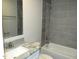Well-maintained bathroom features granite countertops, modern sink and faucet, and ceramic tile shower and floors, ready for use at 734 Baker St, Oxford, NC 27565