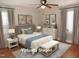 Cozy bedroom featuring a comfortable bed, bedside tables with lamps, and soft neutral decor and ceiling fan at 734 Baker St, Oxford, NC 27565