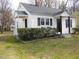 A charming home boasts manicured landscaping and a cozy side porch at 734 Baker St, Oxford, NC 27565