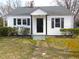 A cozy single-story home featuring black shutters and a classic front entrance at 734 Baker St, Oxford, NC 27565