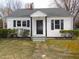 Charming single-story home with black shutters, black door, and well-maintained landscaping at 734 Baker St, Oxford, NC 27565