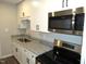 Well-equipped kitchen showcasing granite countertops, stainless steel appliances and white cabinets, ready for gourmet meals at 734 Baker St, Oxford, NC 27565