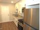 Modern kitchen featuring stainless steel appliances, granite countertops, white cabinets and wood floors, ready for cooking at 734 Baker St, Oxford, NC 27565