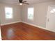 Hardwood floors and neutral walls in this bright living room at 734 Baker St, Oxford, NC 27565