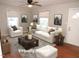 Bright living room featuring hardwood floors, neutral walls, ceiling fan and comfortable seating arrangement at 734 Baker St, Oxford, NC 27565