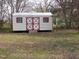 Outbuilding on property with red and white design offers functional outdoor space at 734 Baker St, Oxford, NC 27565