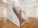 Elegant staircase with wrought iron balusters and wood handrail at 1014 Brittley Way, Apex, NC 27502