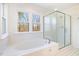 Bathroom includes soaking tub, shower, and two windows at 106 Ortons Point Pl, Cary, NC 27513