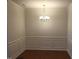 Formal dining room with wainscoting and chandelier at 13 E Milan Ct, Clayton, NC 27527