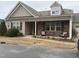 Two-story house with stone and siding, covered porch, and two-car garage at 13 E Milan Ct, Clayton, NC 27527