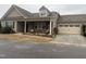 Tan two-story house with stone accents, two-car garage, and covered porch at 13 E Milan Ct, Clayton, NC 27527