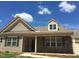 Tan two-story house with brown brick accents and a covered porch at 13 E Milan Ct, Clayton, NC 27527