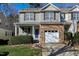 Two-story townhome with stone accents and a purple front door at 155 Jamison Woods Ln, Apex, NC 27539