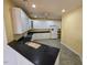 Spacious kitchen with white cabinets and black countertops at 2004 Clyde Bank Ct, Cary, NC 27511