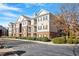 Exterior view of apartments with brick facade, balconies, beautiful landscaping, and ample parking at 2621 Oldgate Dr # 105, Raleigh, NC 27604