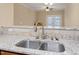 Kitchen sink features updated faucet, granite countertops, stainless steel sink, and tiled backsplash at 2621 Oldgate Dr # 105, Raleigh, NC 27604