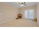 Neutral Living room area with fireplace, ceiling fan, and french doors leading to a patio at 2621 Oldgate Dr # 105, Raleigh, NC 27604