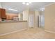 Bright living room showcasing neutral carpet, white trim, and an open floorplan flowing into the kitchen at 2621 Oldgate Dr # 105, Raleigh, NC 27604