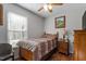Bedroom with wood bed frame, nightstand, and window at 316 Trappers Run Dr, Cary, NC 27513