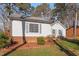 House exterior with gray siding, brick foundation, and landscaping at 316 Trappers Run Dr, Cary, NC 27513