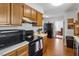 Cozy kitchen featuring wood cabinets, modern appliances, and hardwood floors at 316 Trappers Run Dr, Cary, NC 27513