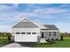 One-story home with gray siding, stone accents, and a two-car garage at 38 Brazan Ct, Fuquay Varina, NC 27526