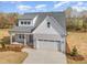 New construction home featuring gray siding, white trim, a two-car garage, and a manicured front lawn at 57 Nottoway Ln, Wendell, NC 27591